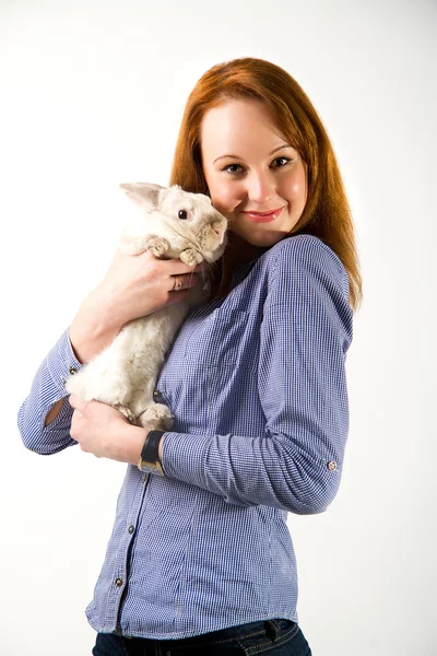 Portrait of sexy woman posing in studio with rabbit — Stock Photo, Image