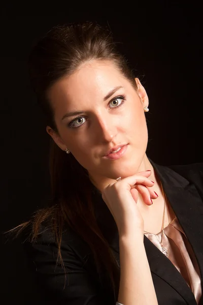 Portrait of beautiful woman posing in studio in jacket — Stock Photo, Image