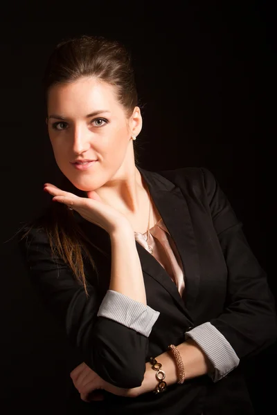 Portrait of beautiful woman posing in studio in jacket — Stock Photo, Image