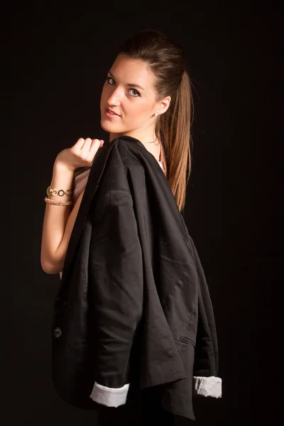 Portrait of beautiful woman posing in studio with jacket — Stock Photo, Image