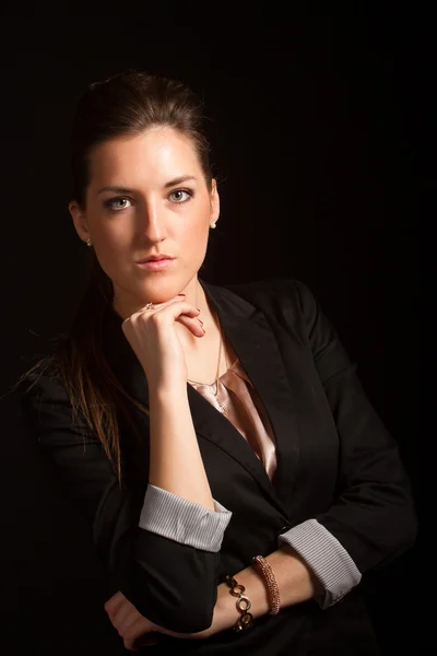 Portrait of beautiful woman posing in studio in jacket Stock Photo