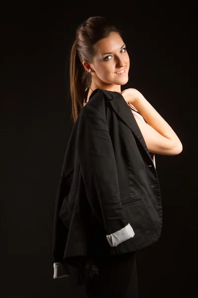 Portrait of beautiful woman posing in studio with jacket — Stock Photo, Image