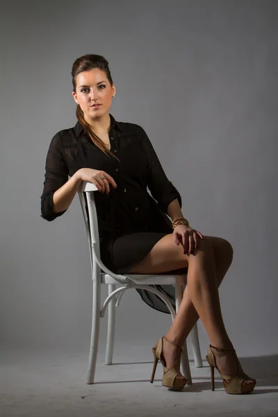 Image of sexy woman sitting on chair — Stock Photo, Image