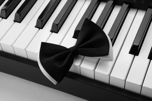 Piano keys and bow — Stock Photo, Image