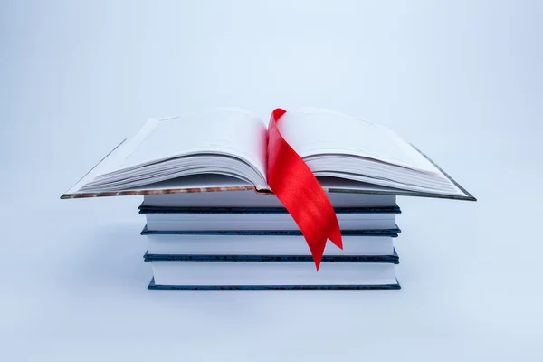 Open book on a pile of books — Stock Photo, Image