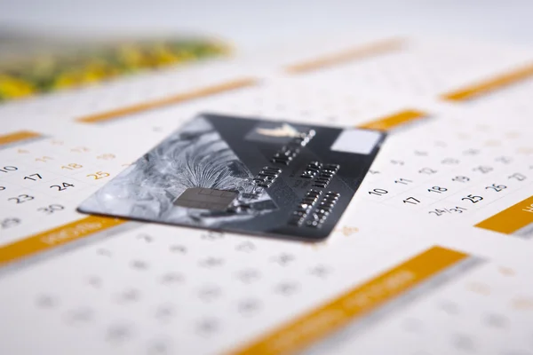 Cartão de banco deitado no calendário — Fotografia de Stock