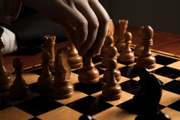 Man makes a move chess figure — Stock Photo, Image