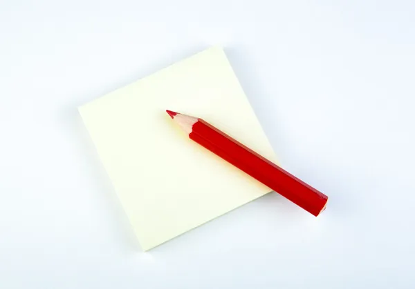 Sheet of paper with red pencil — Stock Photo, Image