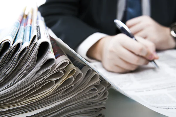 Stack of newspapers in office close-up — Stock Photo, Image