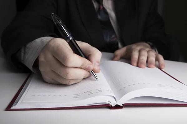 Man is preparing for written work Stock Picture