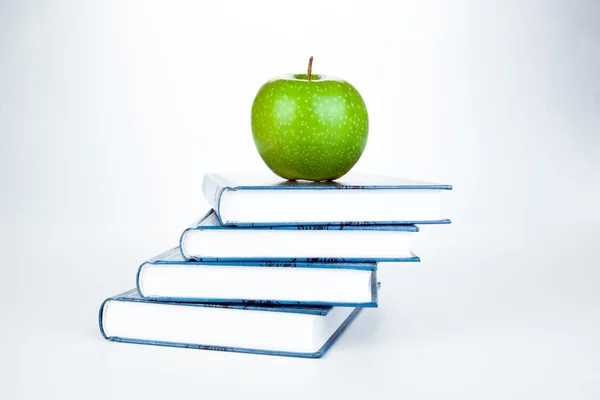 Stack of books with green apple — Stock Photo, Image