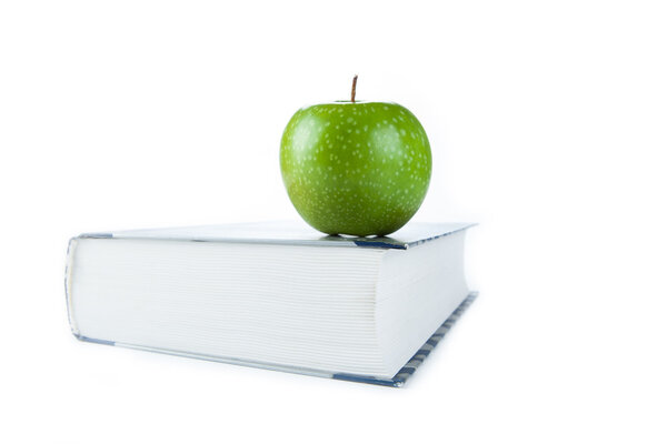 large book with green apple 