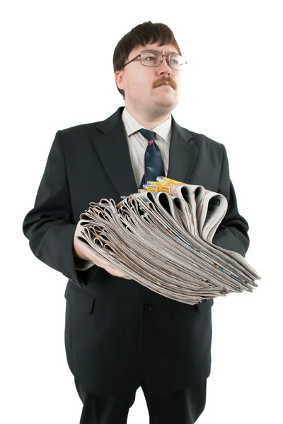 Man holding a stack of newspapers — Stock Photo, Image