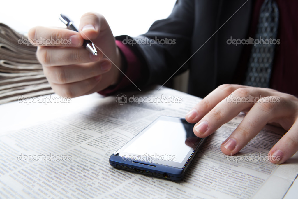 man working on a smartphone in office