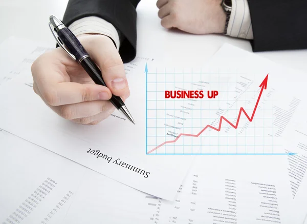 Businessman holding a pen and counts the budget — Stock Photo, Image