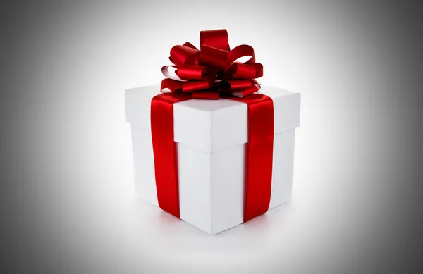 White gift box with red ribbon and bow — Stock Photo, Image