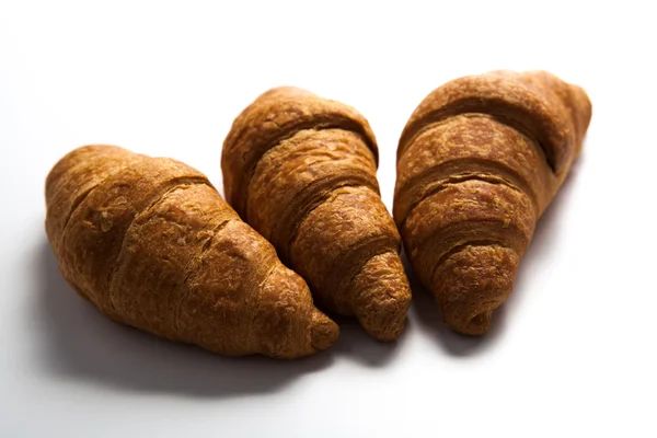 Drie croissant op grijs — Stockfoto