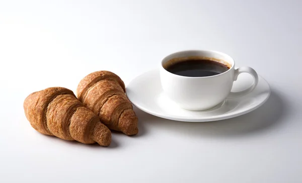 Cup of black coffee with croissants — Stok fotoğraf