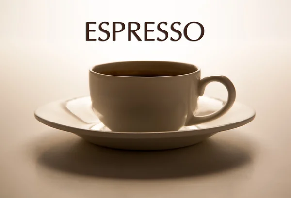 Taza de vidrio y platillo primer plano con título espresso — Foto de Stock