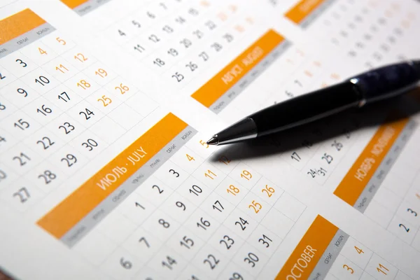 Wall calendar with pen closeup Royalty Free Stock Photos