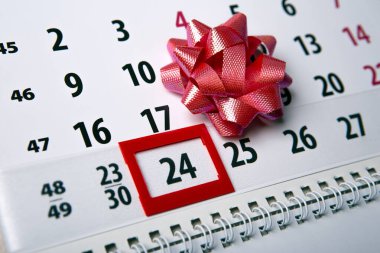 wall calendar with day 24 december and  festive bow 