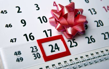 wall calendar with day 24 december and  festive bow 