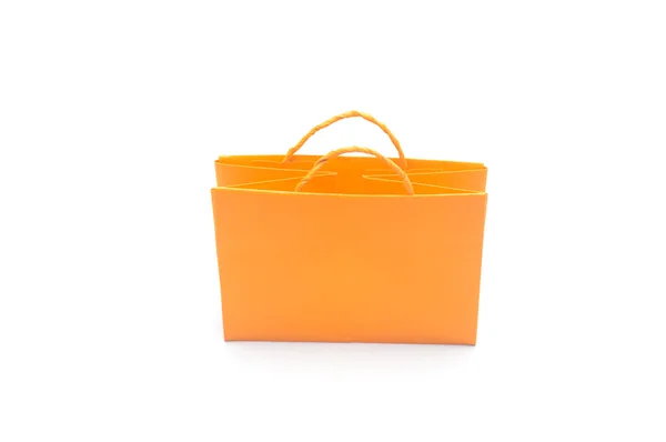 Beyaz arka planda turuncu kağıt çanta — Stok fotoğraf