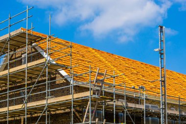 house with scaffolding ready for roof tiling, Rucphen, The Netherlands, 6 may, 2022