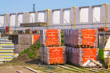 pallets with wienerberger facing bricks on a consturction site, Building materials, construction site in Rucphen, The Netherlands, 6 may, 2022