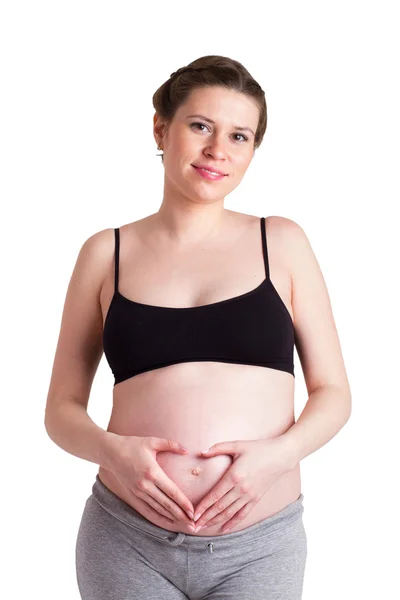 Pregnant woman lying in bed and hugging her belly Royalty Free Stock Images