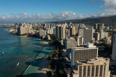Drone, aerial view of downtown Honolulu with Waikiki Beach during sunrise over Oahu
