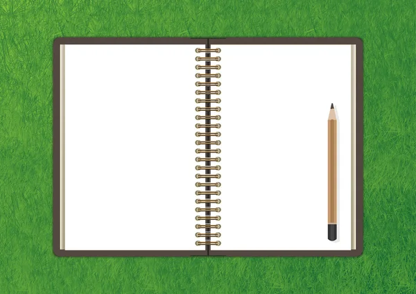 Open notebook with white page and pencil on Green grass backgrou — Stock Photo, Image