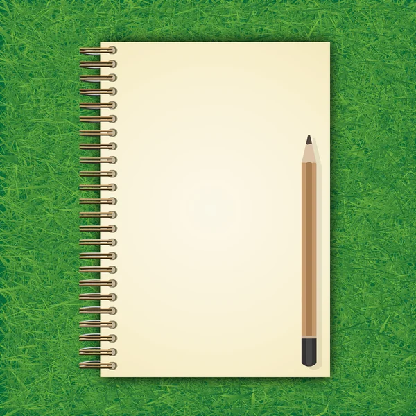 Open notebook with white page and pencil on Green grass backgrou — Stock Photo, Image