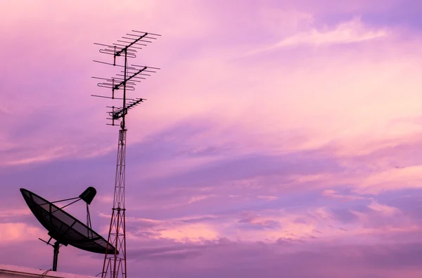 A black satellite dish on twilight sky background — Stock Photo, Image