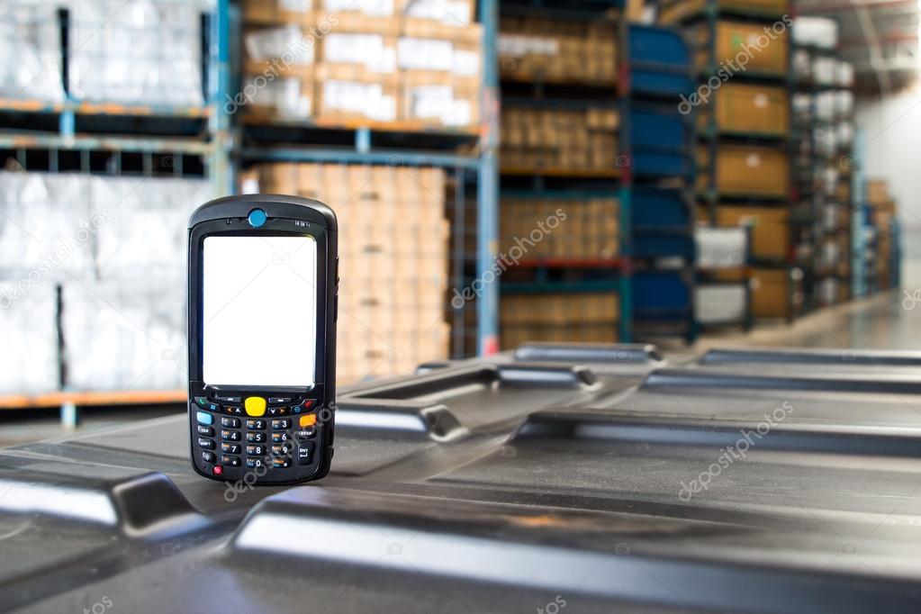 Bluetooth barcode scanner in front of modern warehouse 