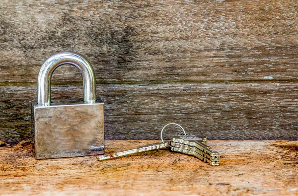 Key and lock on wooden background — Stock Photo, Image