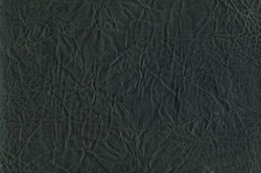 Black bright macro photo of texture of the genuine faux vegan leather. Fashion pattern and background. Leather with embossing.