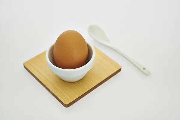 Egg in a eggcup against white background