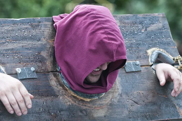 Man punished in a pillory — Stock Photo, Image