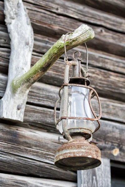 Oil lamp on wooden hut background — Stock Photo, Image