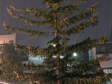 snow falling snowing at night in dolomites mountains