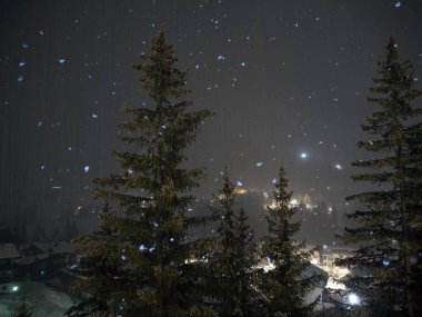snow falling snowing at night in dolomites mountains