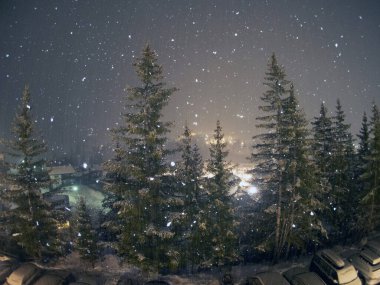 snow falling snowing at night in dolomites mountains