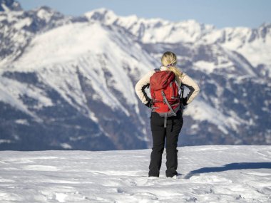 hiker contemplating dolomites mountains in winter and relaxing