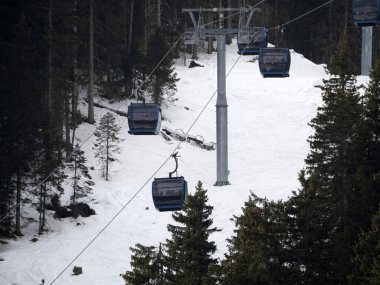 cable way many skiers skiing in dolomites gardena valley snowy mountains 