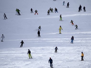 many skiers skiing in dolomites gardena valley snowy mountains 