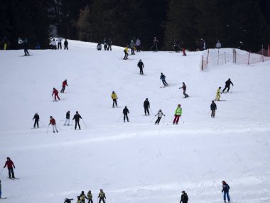 many skiers skiing in dolomites gardena valley snowy mountains 