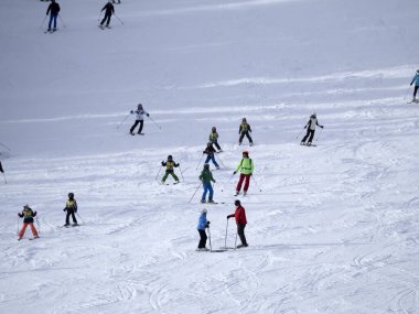 many skiers skiing in dolomites gardena valley snowy mountains 