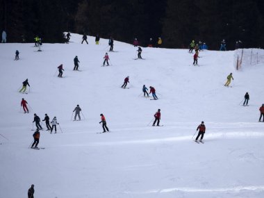 many skiers skiing in dolomites gardena valley snowy mountains 