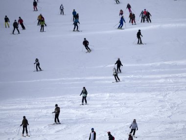 many skiers skiing in dolomites gardena valley snowy mountains 